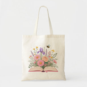 Geopend boek met uitbarstende wilde bloemen en bij tote bag