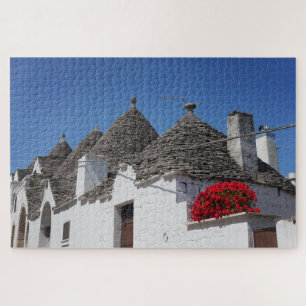 Geraniumbloemen en boomgaarden in Alberobello Legpuzzel