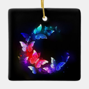 Gloeiende neon nacht vlinders op zwarte achtergron keramisch ornament