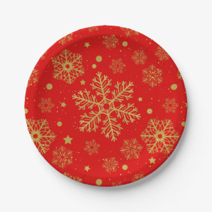 Golden sneeuwvlokken op rood papieren bordje