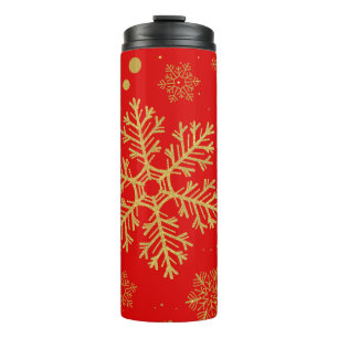 Golden sneeuwvlokken op rood thermosbeker