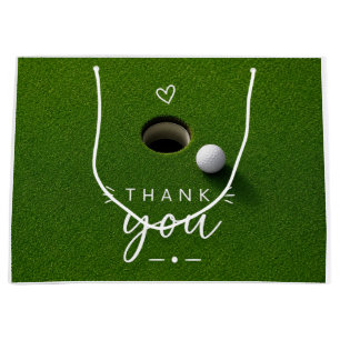 Golfbal naast hole op groen gras Bedankt  Groot Cadeauzakje