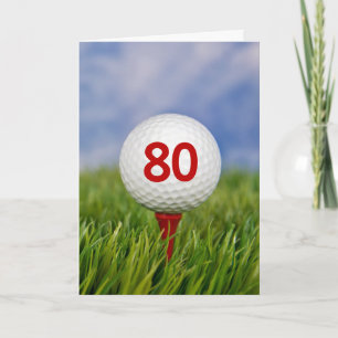 Golfbal voor 80ste verjaardag op rode tee kaart
