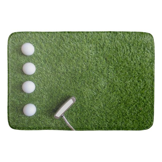 Golfballen zijn op groen grasbadmat badmat (Voorkant)