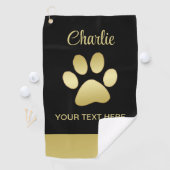 Gouden glanzende hondenpoot op zwarte achtergrond golfhanddoek (Insitu)