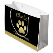 Gouden glanzende hondenpoot op zwarte achtergrond groot cadeauzakje