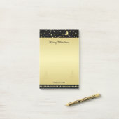 Gouden glanzende kerststerren, poten op goud & zwa post-it® notes (Op bureau)