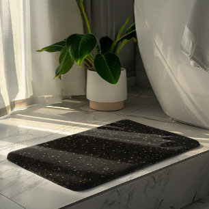 Gouden glitters en vonken op zwart badmat