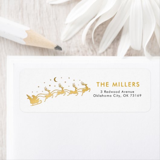 Gouden Kerstman die in een slee met rendieren vlie Etiket (Insitu)