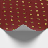 Gouden kruisbloemige bloemen op donkerrood cadeaupapier (Hoek)