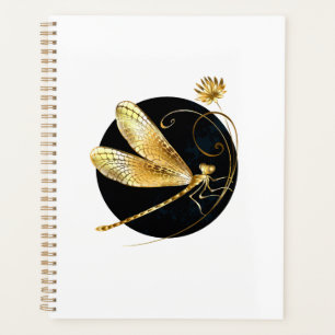 Gouden libel in zwarte cirkel planner