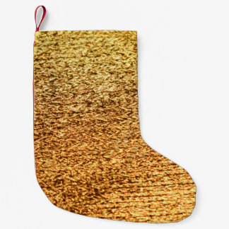 Gouden textiel: glamoureuze macro achtergrond. kleine kerstsok