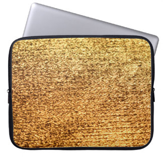 Gouden textiel: glamoureuze macro achtergrond. laptop sleeve