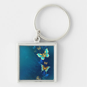 Gouden vlinders op een blauwe achtergrond sleutelhanger