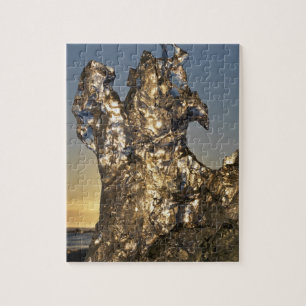 Gouden zonsopgang gezien door ijsbergformatie legpuzzel