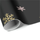 Goudglitter en roze sneeuwvlokken op zwarte kerst cadeaupapier (Rol Hoek)