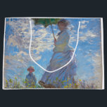 Grand Sac Cadeau Femme avec Parasol, Monet<br><div class="desc">Oscar-Claude Monet (14 novembre 1840 - 5 décembre 1926) était un peintre français, un fondateur de la peinture impressionniste française et le praticien le plus constant et le plus prolifique de la philosophie du mouvement d'exprimer ses perceptions avant la nature, surtout en ce qui concerne la peinture en plein air...</div>
