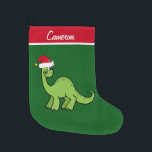 Grande Chaussette De Noël Dinosaure pour enfants mignon<br><div class="desc">Dinosaure vert cool enfants bas de Noël Cet apatosaure semble très mignon dans un chapeau de Noël rouge de vacances avec un petit sourire. J'aime les animaux de Noël préhistoriques et les cadeaux que les enfants vont aimer. Customisez ce cadeau avec le nom du destinataire pour le rendre encore plus...</div>