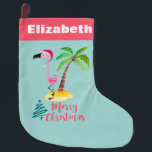 Grande Chaussette De Noël Noël de l'île tropicale Flamant rose rose<br><div class="desc">Un réveil festif de Noël avec une touche d'île tropicale aux couleurs pastel. Une jolie illustration d'un flamant rose dans un chapeau de santa rouge. À côté d'un palmier vert sur un monticule de sable jaune. Un design d'arbre de Noël tourbillonnant est placé à côté du texte Joyeux Noël. Écrit...</div>