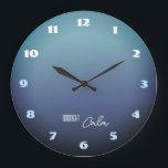 Grande Horloge Ronde Midnight Calm Gradient<br><div class="desc">A stylish wall clock inspired by the quiet beauty of midnight. The soft gray-blue gradient background evokes a calm night sky illuminated by moonlight. Bold modern numbers in white and turquoise create a striking contrast while keeping the design balanced and elegant. The “Midnight Calm” message adds a peaceful, relaxing mood—perfect...</div>