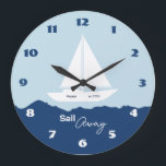Grande Horloge Ronde Nautical Sailboat<br><div class="desc">Stylish nautical wall clock featuring a white sailing boat silhouette on a soft blue background with deep blue ocean waves. The design captures the peaceful feeling of the sea and open horizons. The phrase “Sail Away” adds a sense of adventure and freedom, perfect for lovers of the ocean and coastal...</div>