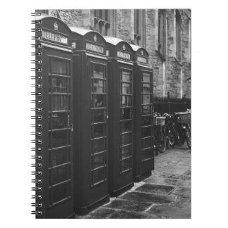 GRAYSCHAALFOTO VAN VIER TELEFOONBOOTHEN DIE VERBON NOTITIEBOEK