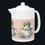 Grenouille lunaire en Teacup Floral<br><div class="desc">Une charmante grenouille verte surplombe une délicate tasse en porcelaine ornée de fleurs roses douces et de garnitures dorées, couronnée d'une couronne de fleurs pastel et d'une minuscule couronne royale. Cette scène attachante mêle fantaisie de conte de fées à l'élégance du cottagecore, évoquant une douce nostalgie et des vibes ludiques...</div>