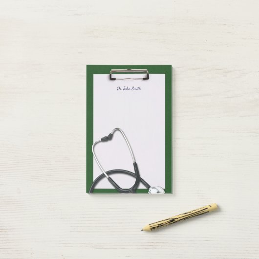 Groen medisch klembord met stethoscoop post-it® notes (Op bureau)