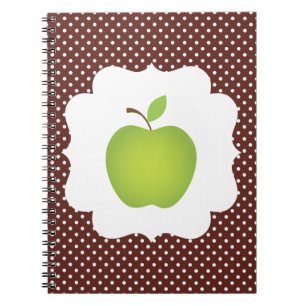 Groene appel op bruine achtergrond met polkadots notitieboek