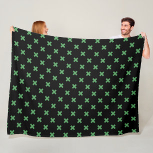 Groene kruisstiften op zwart fleece deken