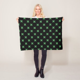 Groene kruisstiften op zwart fleece deken