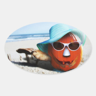 Halloween pompoen aan het strand ovale sticker