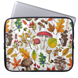 Herfst paddenstoelen, bladeren, noten en bessen op laptop sleeve