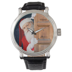 Het is de kerstman! zich verstoppen achter een hou horloge
