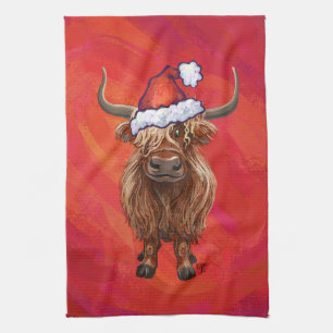 Highland koe in Santa Hat op rood Theedoek