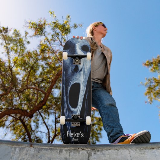 Hollow-eyed phantom witch etching on blue-black skateboard (Buiten 1)