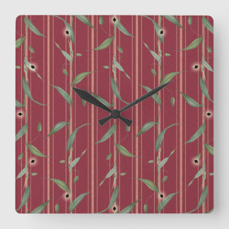 Horloge Carrée Branche de feuilles sur papier peint rouge