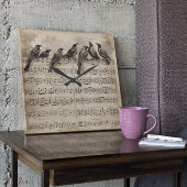 Horloge Carrée chant d'oiseaux assis sur une composition musicale