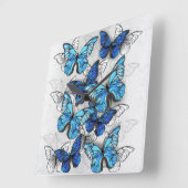 Horloge Carrée Composition de papillons blancs et bleus (Angle)