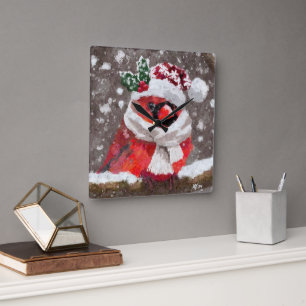 Horloge Carrée Écharpe et chapeau Cardinal Bird dans Noël enneigé