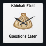 Horloge Carrée Khinkali<br><div class="desc">Khinkali is a traditional Georgian dish that has become a symbol of Georgian hospitality. These large, hand-crafted dumplings are filled with a savory mixture of minced meat (usually beef and pork), herbs, and spices. The dough is carefully wrapped around the filling, creating a beautiful knot at the top, which also...</div>