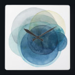 Horloge Carrée Planètes en évolution - Cercles d'aquarelle<br><div class="desc">Planètes en évolution I par Grace Popp. Les cercles d'aquarelle créent des formes semblables à des planètes qui se chevauchent pour révéler de belles variations de bleu et de turquoise.</div>