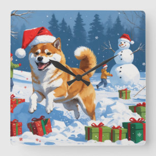 Horloge Carrée Shiba Inu courant dans la neige avec un chapeau de