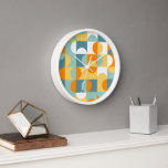 Horloge Orange Jaune Turquoise Bleu Mer Motif Art Rétro<br><div class="desc">Beau contemporain blanc, jaune, orange, bleu turquoise et maritime seaglass vert cercles géométriques et demi-cercles motif.. Elégant, élégant et éclectique design minimalisme pour le décorateur artistique, décorateur artistique, branché populaire, style d'art rétro vintage ou abstrait amateur de motifs géométriques numériques. Associez ce design à vos couleurs de décoration intérieure et...</div>