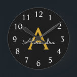 Horloge Ronde Black Gold Modern Script Girl Monogramme Nom<br><div class="desc">Black and Gold Simple Script Monogram Clock. This makes the perfect sweet 16 birthday,  wedding,  bridal shower,  anniversary,  baby shower or bachelorette party gift for someone that loves glam luxury and chic styles.</div>