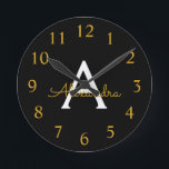 Horloge Ronde Black Gold Modern Script Girl Monogramme Nom<br><div class="desc">Black and Gold Simple Script Monogram Clock. This makes the perfect sweet 16 birthday,  wedding,  bridal shower,  anniversary,  baby shower or bachelorette party gift for someone that loves glam luxury and chic styles.</div>