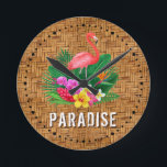 Horloge Ronde Flamant rose Floral Paradise<br><div class="desc">Un flamant rose,  des fleurs tropicales et des feuilles sur motif tissé en osier et le mot PARADISE fait une horloge murale élégante à thème d'été. CORRESPONDRE des articles dans notre magasin.</div>