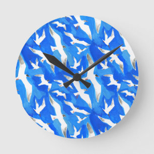 Horloge Ronde Flying seagulls on sky blue