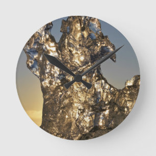 Horloge Ronde Lever de soleil doré vu à travers une formation d'