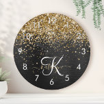 Horloge Ronde Monogramme à étincelle noire à Parties scintillant<br><div class="desc">Personnalisez facilement ce design élégant et tendance,  24h/24,  avec une jolie parties scintillant dorée brillante sur un arrière - plan métallique brossé noir.</div>